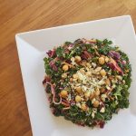 A satisfyingly crunchy kale salad with carrots, cabbage, and crunchy quinoa all tossed with buffalo sauce and blue cheese